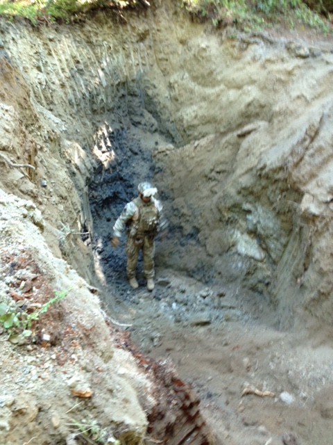 Deputy standing in man made hole which is taller than deputy